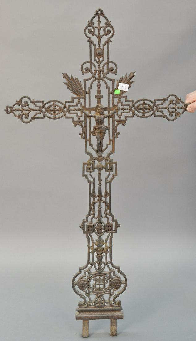 Large metal cross with pierced scrolling motif and: Large metal cross with pierced scrolling motif and crucified Christ at center, two prongs at base, light wear, 55 1/2"h. x 29" w., [Provenance: Former home of Mel Gibson, Old Mill Rd, Greenwich, CT].