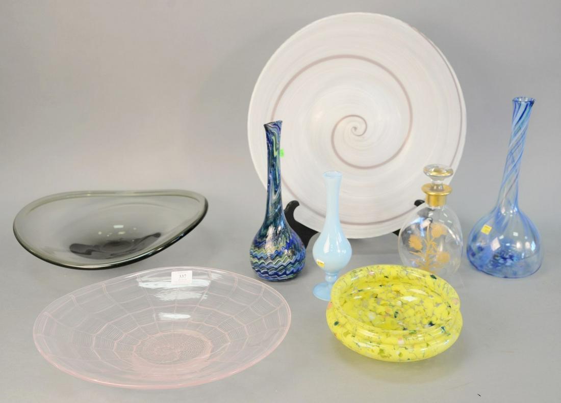 Eight pieces of glass including: a Pfeiffer Ridge: Eight pieces of glass including: a Pfeiffer Ridge Studios charger, 18" diam.; two fluted vases, blue with stripes, signed illegibly to base, taller: 14" h.; Holmegaard console bowl, 16" diam.; pink bo