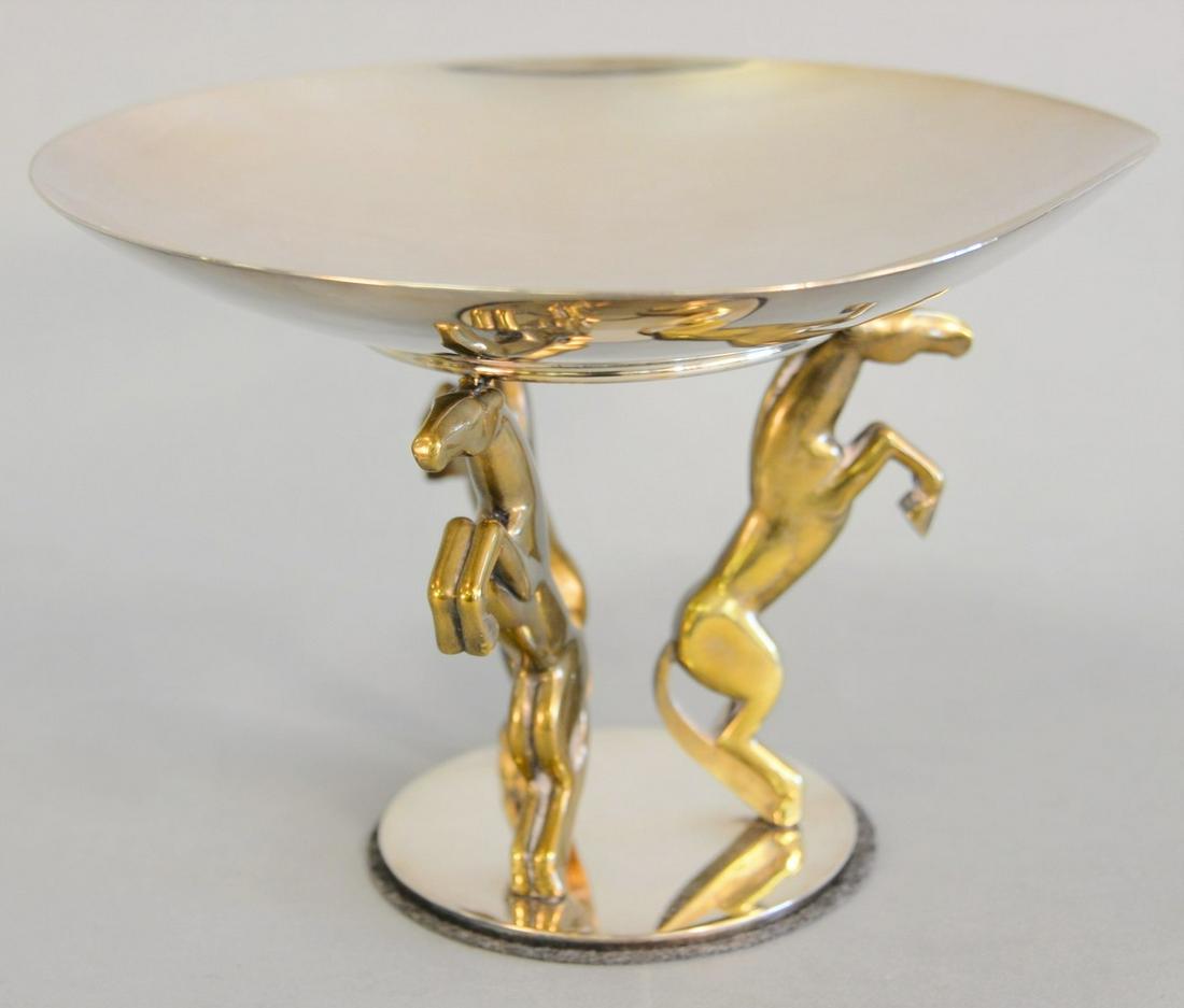 Puiforcat silverplate compote on figural tripod base of: Puiforcat silverplate compote on figural tripod base of bronze tone rearing horses, 7". [Property from the Collection of Ginny and Henry Mancini].