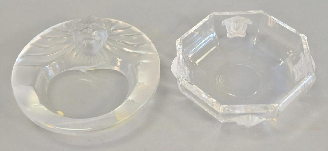 Two glass dishes including Versace by Rosenthal: Two glass dishes including Versace by Rosenthal octagonal dish with four Versace medusa symbols to sides, signed "Rosenthal Versace" to base, ht. 1 1/2", dia, 5"; and a Lalique lion bowl, signed "Lali