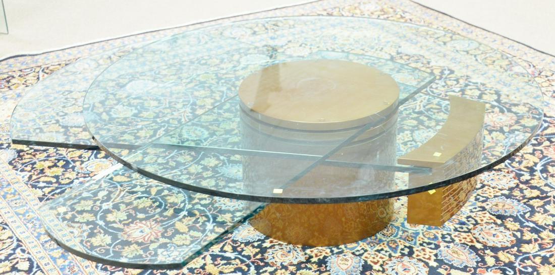 Dakota Jackson, self-winding coffee table, has three: Dakota Jackson, self-winding coffee table, has three moving glass components, ht. 17", dia. 54".