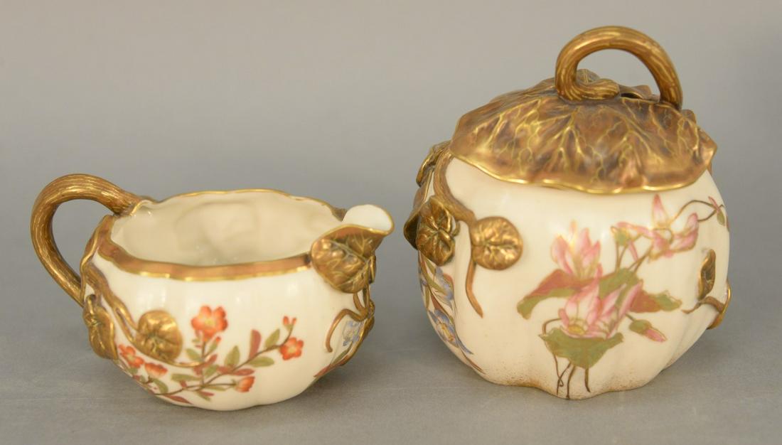 Royal Worcester lotus creamer and covered sugar, having: Royal Worcester lotus creamer and covered sugar, having gilt decorated lotus cover handle and decoration, 2 1/2" x 5 1/2", purple mark on bottom. Provenance: The Estate of Ed Brenner, Short Hills N.J.