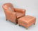 Two-piece lot to include leather chair with ottoman,