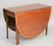 Banded inlaid mahogany dining table having drop leaves,