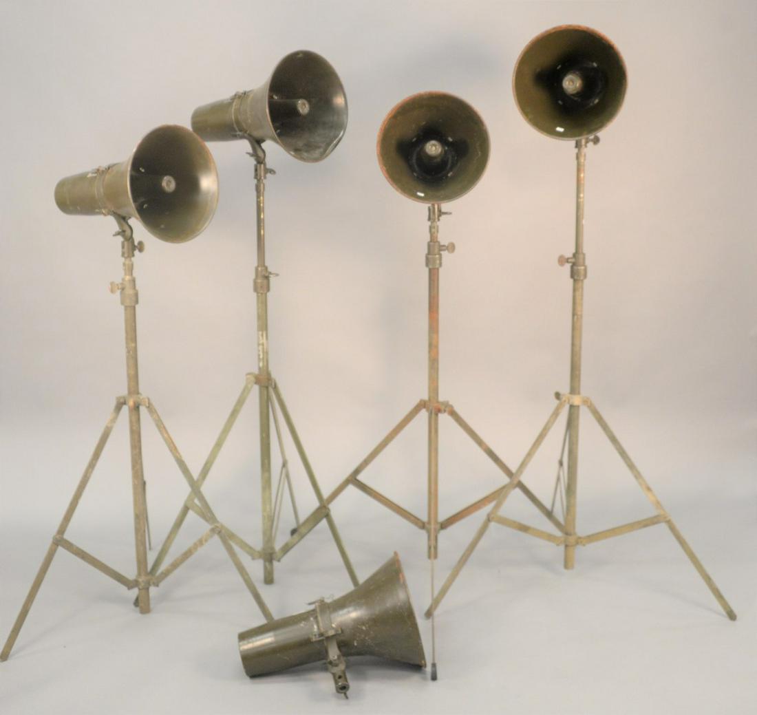 Five WWII era loudspeakers, four having tripod stands. (1 of 4)