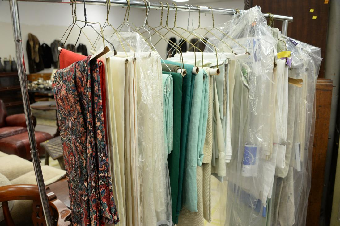 Rack of tablecloths and linens, some large.: Rack of tablecloths and linens, some large.