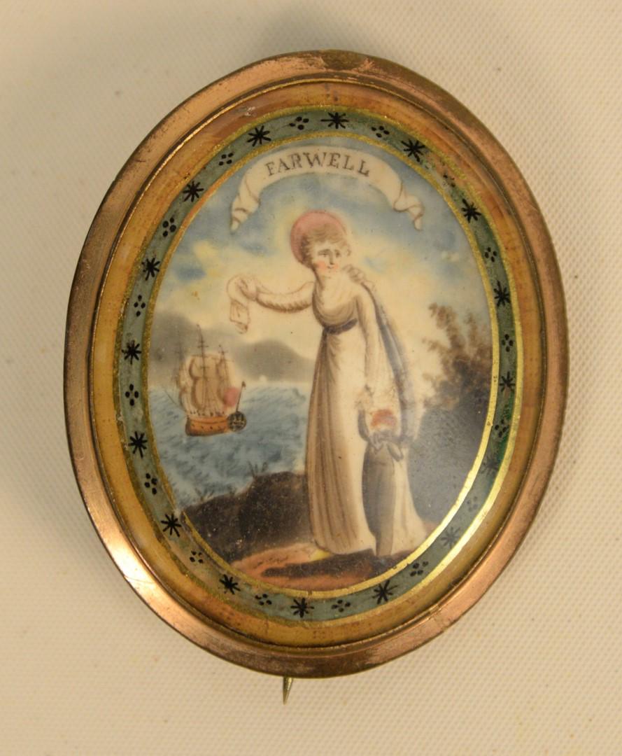 Memorial Pin of lady and child crying while waving: Memorial Pin of lady and child crying while waving farewell with ship in background, having two lockets of hair in back. 1 5/8" x 2".Provenance: From the Lance & Irma Keller Collection, Bloomfield, Co
