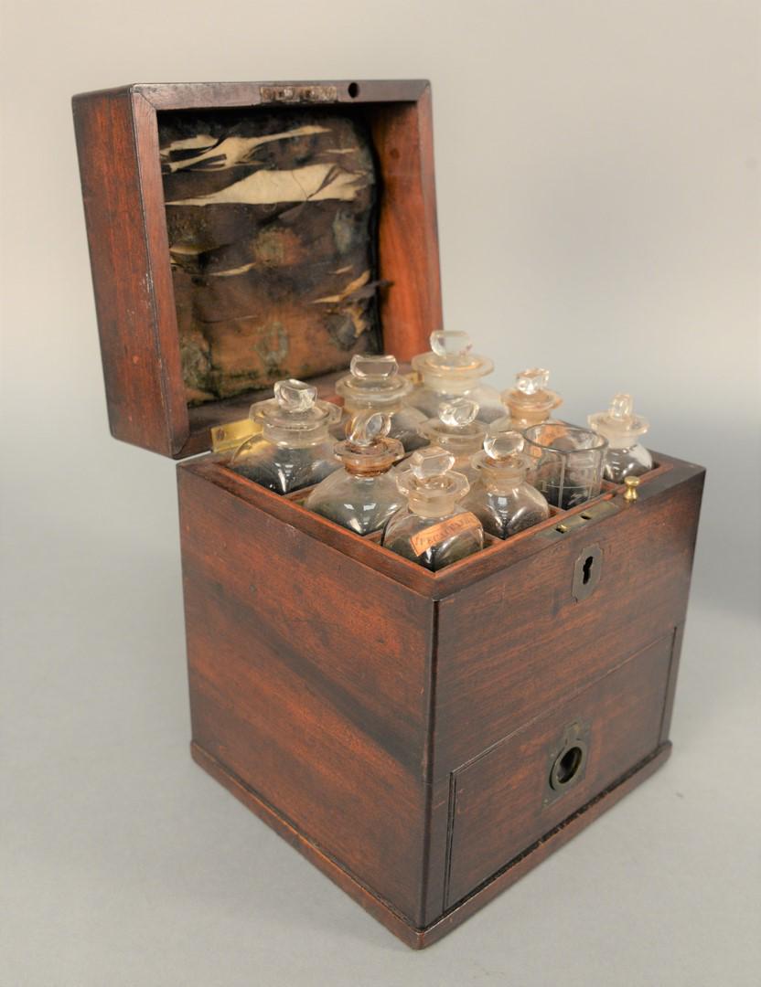 Mahogany Medical Apothecary Box, comprising of fitted: Mahogany Medical Apothecary Box, comprising of fitted interior with seven bottles and a beaker, drawer opening to scale, mortar and pestle and additional bottles, brass handle on top, 19th century.hei