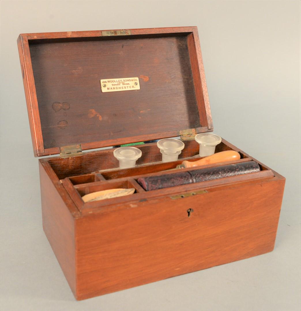 English Mahogany Medical Box having lift-top opening to: English Mahogany Medical Box having lift-top opening to fitted interior consisting of four bottles and thermometer in silver holder, label on lid Jas. Woolley Sons & Co., LTD, Manchester.height: 4 1/2