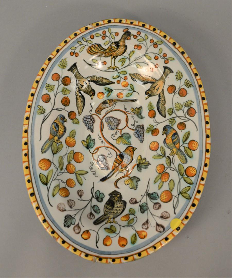 Earthenware Oval Deep Platter with birds and fruit with: Earthenware Oval Deep Platter with birds and fruit with two labels on reverse "Roger Vernon and Ginsburg and Levy.12" x 16".Provenance: The Estate of Diana Atwood Johnson