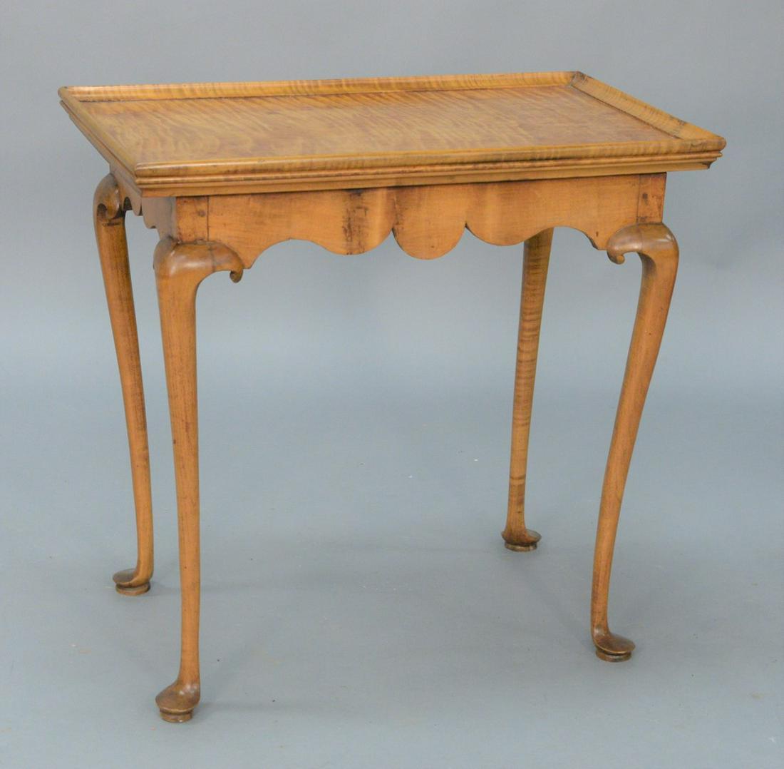 Queen Anne Maple and Tiger Maple Tea Table, having: Queen Anne Maple and Tiger Maple Tea Table, having rectangular dish top over scalloped skirt set on cabriole legs ending in pad feet. height 26 1/4 inches, top 17 1/2" x 27 3/4".Provenance: From the L