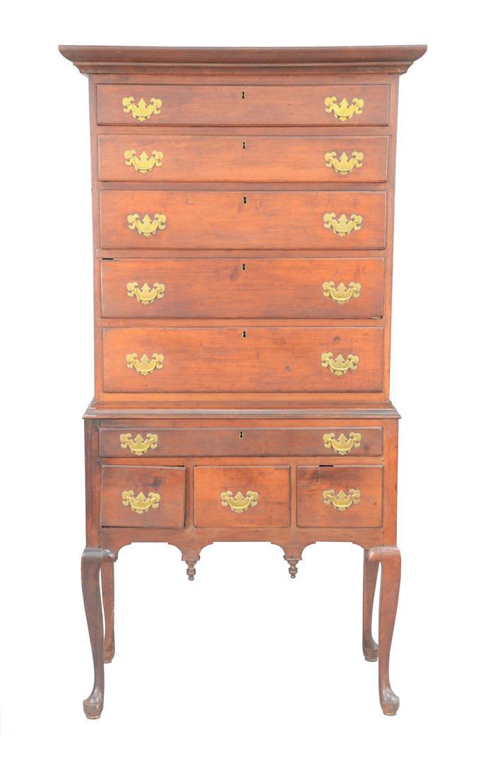Queen Anne Cherry High Chest in two parts, upper: Queen Anne Cherry High Chest in two parts, upper section with large cornice molding over five drawers on lower section with one long drawer over three short drawers all set on cabriole legs ending in 