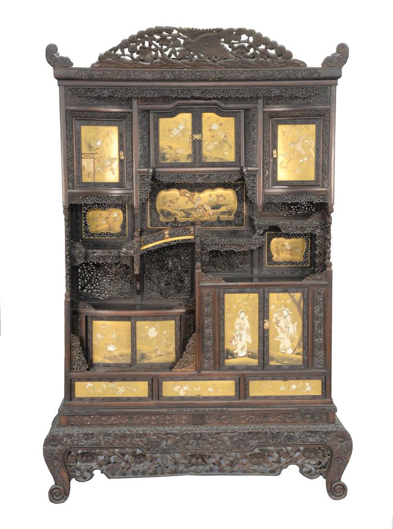Japanese Meiji carved and painted cabinet having gilt: Japanese Meiji carved and painted cabinet having gilt painted doors with bone and mother of pearl inlays featuring figures, birds, and flowering trees, intricately carved and pierced carved frame and 