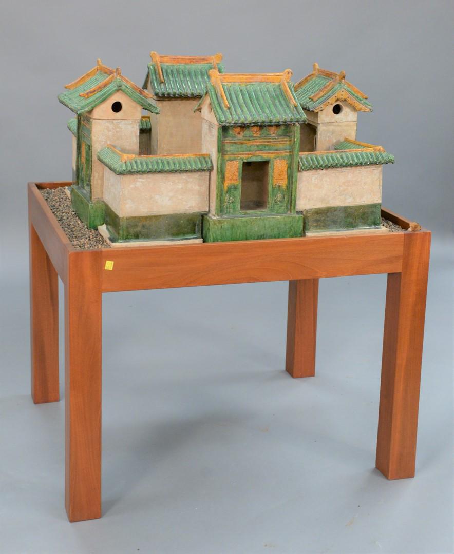 Chinese Model of a Village, green and amber glazed: Chinese Model of a Village, green and amber glazed pottery having four houses with connected wall surround on stand in plexiglass box.height 45 1/2 inches, top 28" x 34".