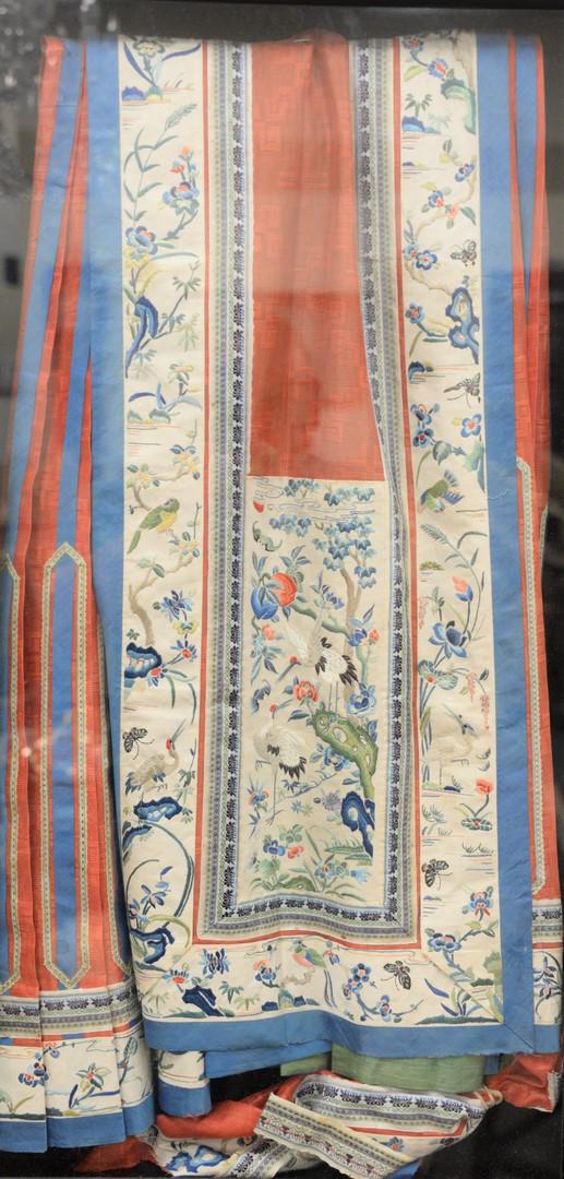 Chinese Silk Embroidered Wall Hanging or Panel having: Chinese Silk Embroidered Wall Hanging or Panel having red silk ground, white border embroidered with birds, cranes and flowers, folded in a shadow box frame. sight size: 30 1/4" x 15 1/2".Provenance: 