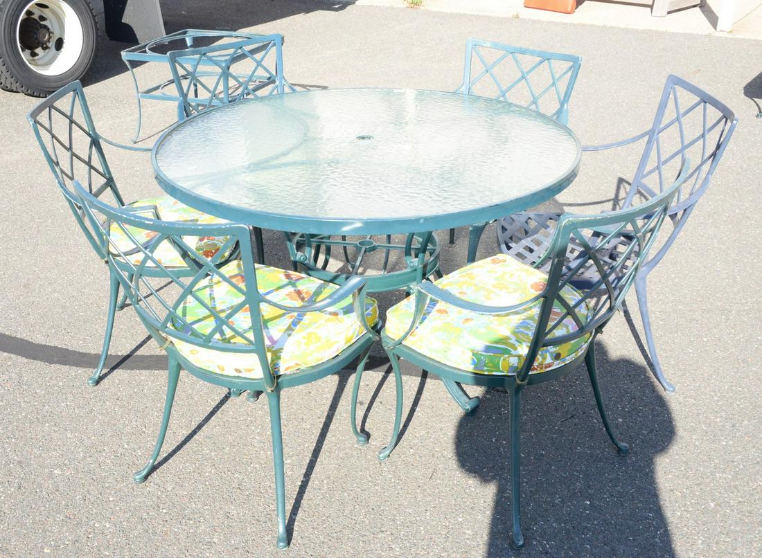 Eleven piece outdoor lot to include round glass top: Eleven piece outdoor lot to include round glass top table, six chairs, a loveseat, and three tables.