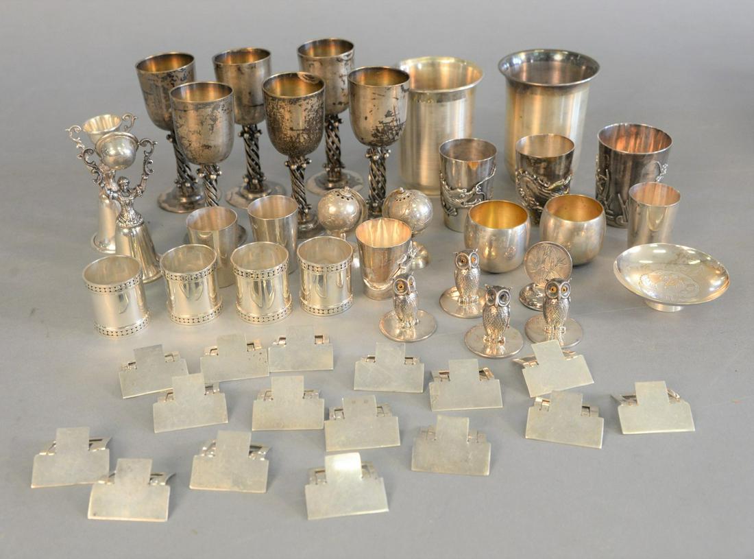 Sterling silver lot with place card holders, four with: Sterling silver lot with place card holders, four with owls, one with glass eyes missing, two tiffany shot glasses, stem cups, Japanese silver cups, etc., 38.8 t.oz.