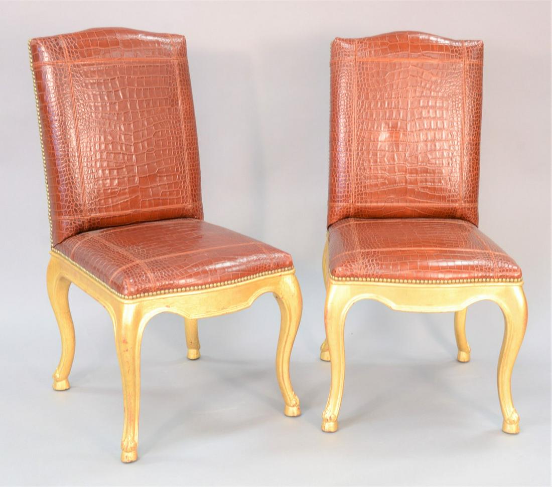 Fourteen Ralph Lauren Dufie dining chairs, upholstered: Fourteen Ralph Lauren Dufie dining chairs, upholstered with cognac alligator embossed leather and nail bead trim, cabriole legs with hoof feet, sun-faded, two chairs are in rough condition, 41 1/2" x 