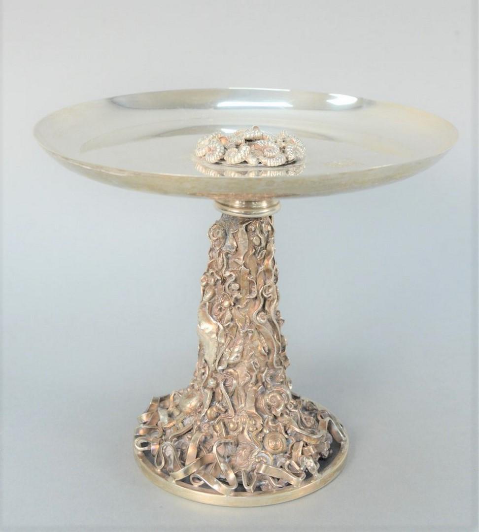 Jocelyn Burton Sterling Silver Compote having round: Jocelyn Burton Sterling Silver Compotehaving round dish top with seashell center, resting on crustation seashell molded stem, hallmarked on side JB, lion, mask, Q;height 7 1/2 inches, diameter 8 3/4 i