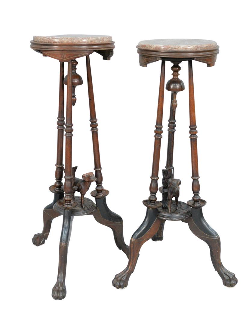 Pair of Walnut Victorian Stands each with brown round: Pair of Walnut Victorian Stands each with brown round marble tops, on turned supports, with carved dog above tripod base, ending in claw feetheight 35 1/2 inches, diameter 12 inchesProvenance: Thirty-