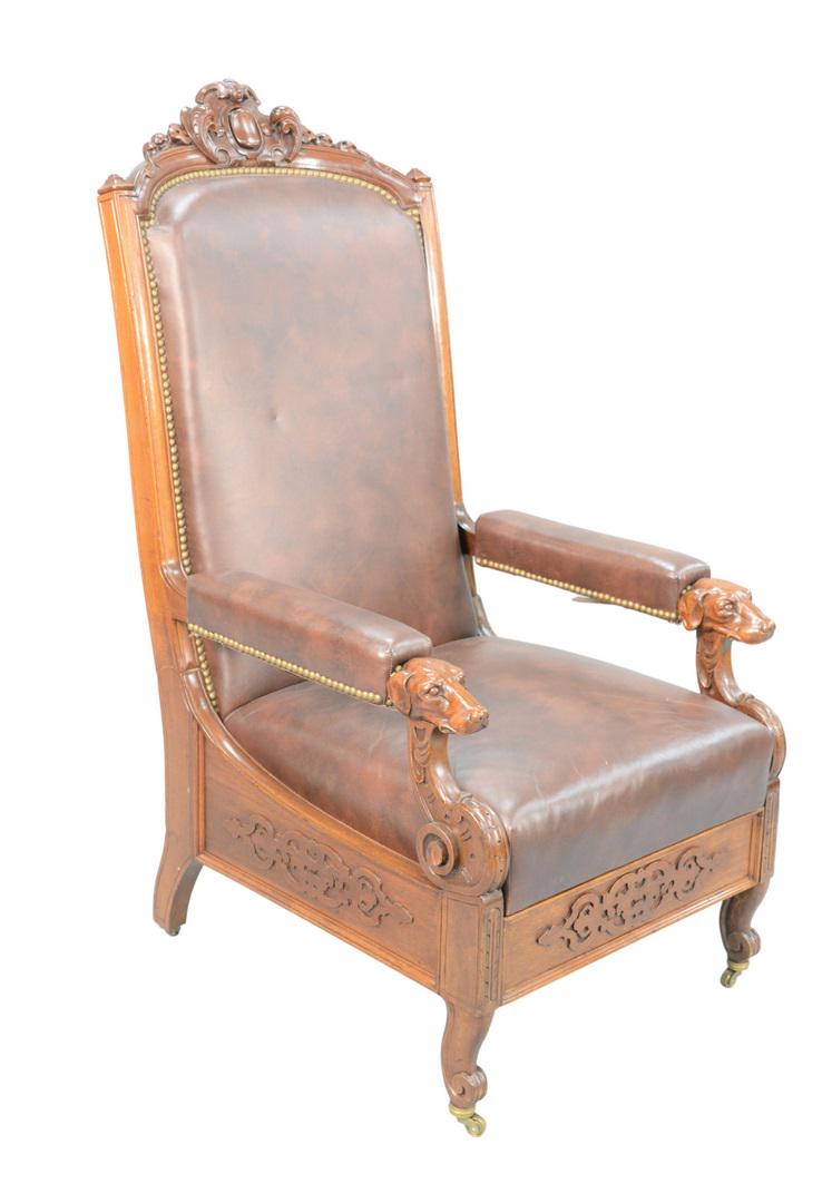 Victorian Walnut Reclining Chair with brown leather: Victorian Walnut Reclining Chairwith brown leather upholstery, and carved dog head hand supports, with pullout foot supportheight 49 1/2 inchesProvenance: Matthes-Theriault Collection, Woodbridge, Con