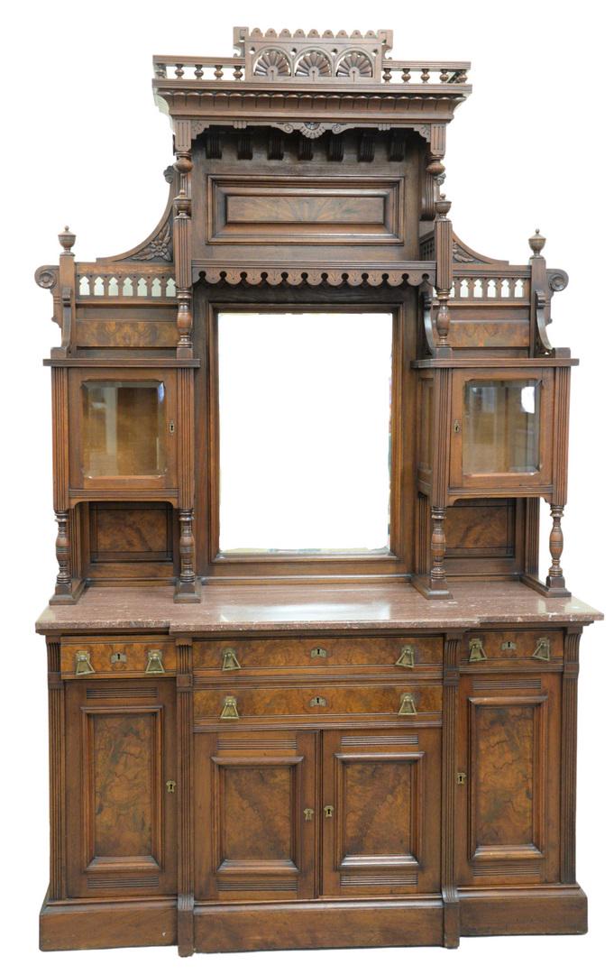 Aesthetic Walnut and Burl Walnut Sideboard in two: Aesthetic Walnut and Burl Walnut Sideboardin two parts, upper section with hooded top over mirror, flanked by curio cabinets on lower section, with brown marble top, on cabinet baseheight 101 inches, 