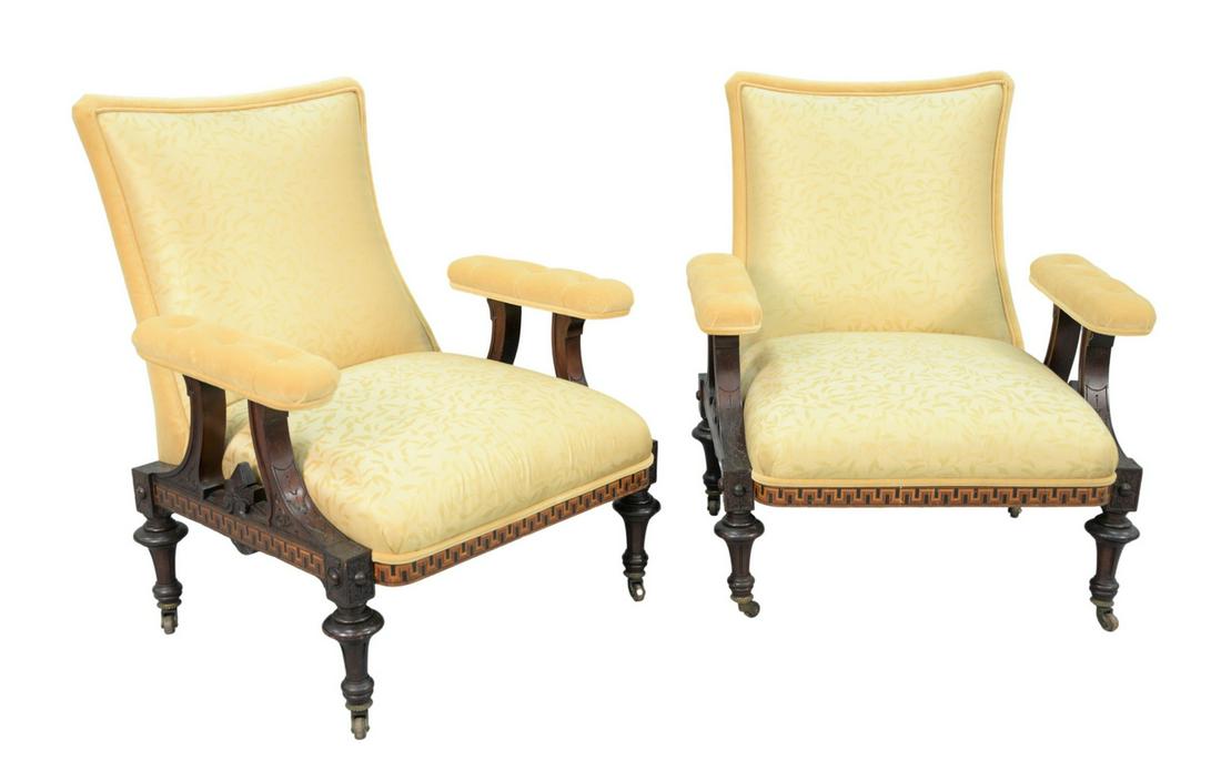 Pair of Renaissance Revival Open Armchairs with custom: Pair of Renaissance Revival Open Armchairswith custom upholstered seat, back and arm over Greek key, inlaid frame on turned legs, with brass supported wood wheelsheight 36 inches, width 31 inchesProve