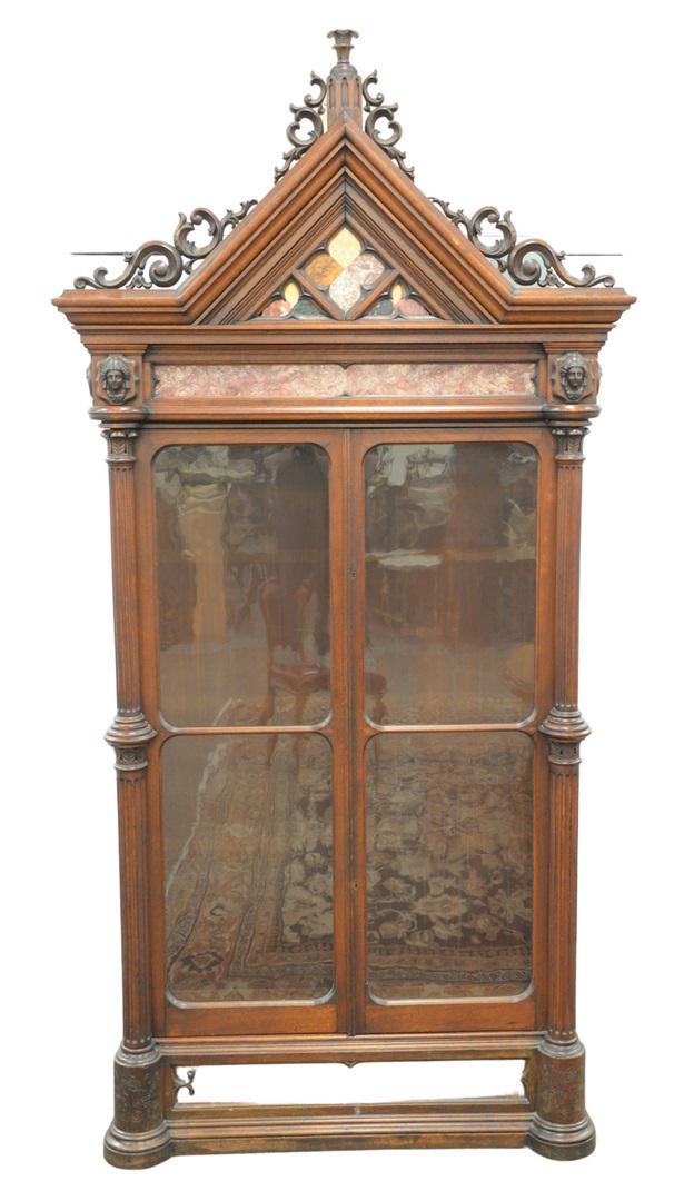 Victorian Walnut Gothic Cabinet having pierced carved: Victorian Walnut Gothic Cabinethaving pierced carved pediment over specimen marble inlaysflanked by two faces over two glass doors flanked by large fluted columns, with inlaid marble bottom on plain b