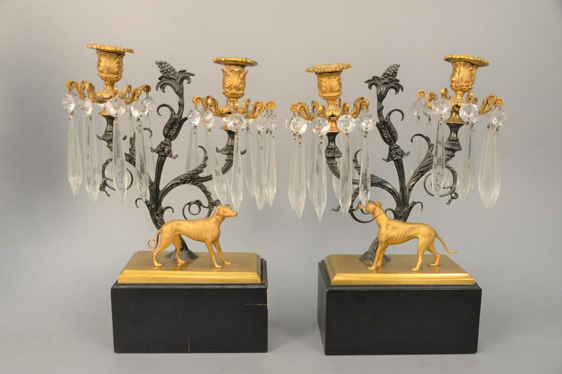 Pair of Regency Dog Candelabra each having two: Pair of Regency Dog Candelabraeach having two scrolling arms supporting, two candle holders, with prisms above standing Whippet, on rectangle baseheight 14 inches, width 4 1/2 inchesProvenance: Estate