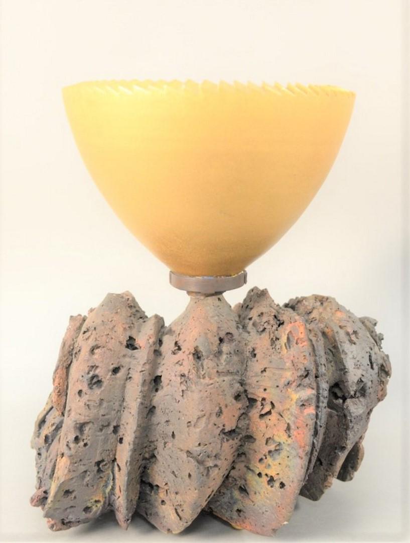 Adrian Saxe (b. 1943) gold bowl on Raku fired ceramic,: Adrian Saxe (b. 1943)gold bowl on Raku fired ceramic, natural baseheight 16 1/4 inches, diameter 10 3/4 inches, length 12 1/2 inchesProvenance: Garth Clark Gallery, New York, receipt, 2/02/1990, $9,50