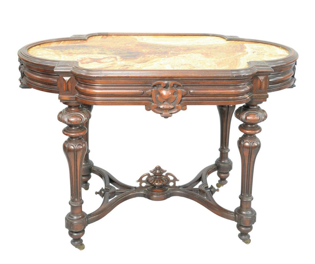 Renaissance Revival Walnut Table with unusual inset: Renaissance Revival Walnut Tablewith unusual inset marble on round legs, with center urn and stretchers(marble professionally repaired and reinforced)height 29 1/2 inches, top 27" x 45"Provenance: Thi