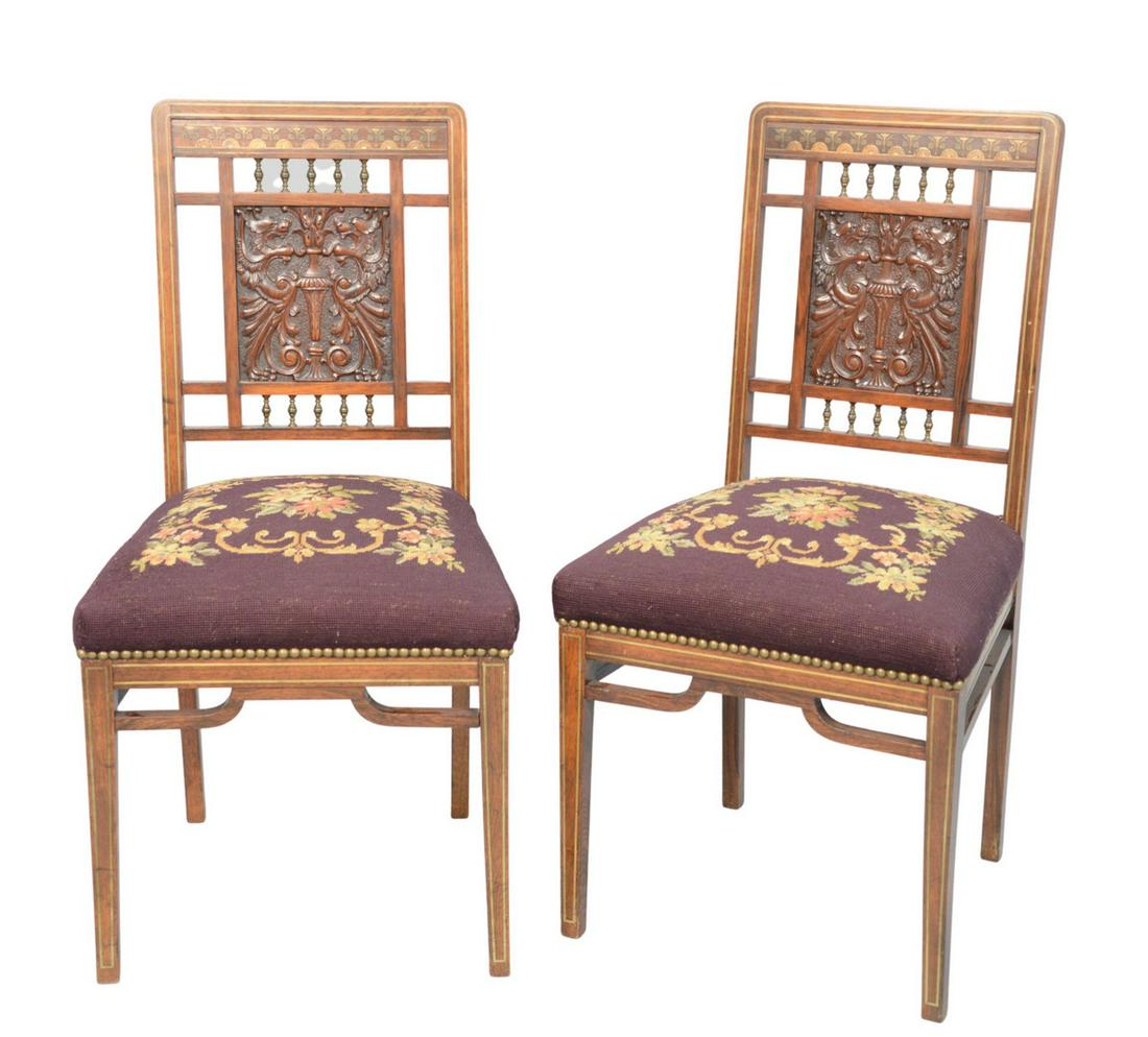 Pair of Aesthetic Rosewood Slipper Chairs having: Pair of Aesthetic Rosewood Slipper Chairshaving multi-metal inlays, over carved griffin panel, with brass spindles, and needlepoint seatsseat height 17 inchesprobably New York, circa 1890height 34 1/2
