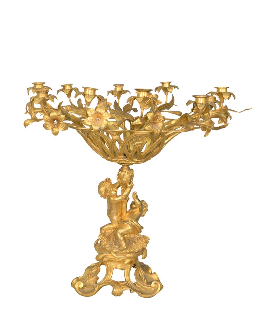 Large French Gilt Bronze Centerpiece having flower: Large French Gilt Bronze Centerpiecehaving flower basket, surrounded by ten candle holders and flowers, supported by two Putti shaft and Rococo baseheight 21 1/2 inches, width 24 inches, depth 18 inch