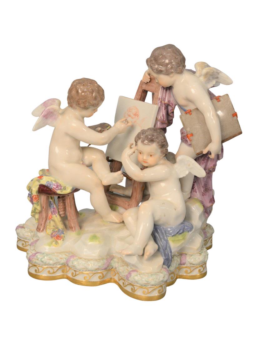 Meissen Porcelain Figural Group having three winged: Meissen Porcelain Figural Grouphaving three winged Puttis painting a portrait, cross swords mark in underglaze blue (chips) on bottomheight 7 1/4 inches, length 6 3/4 inches