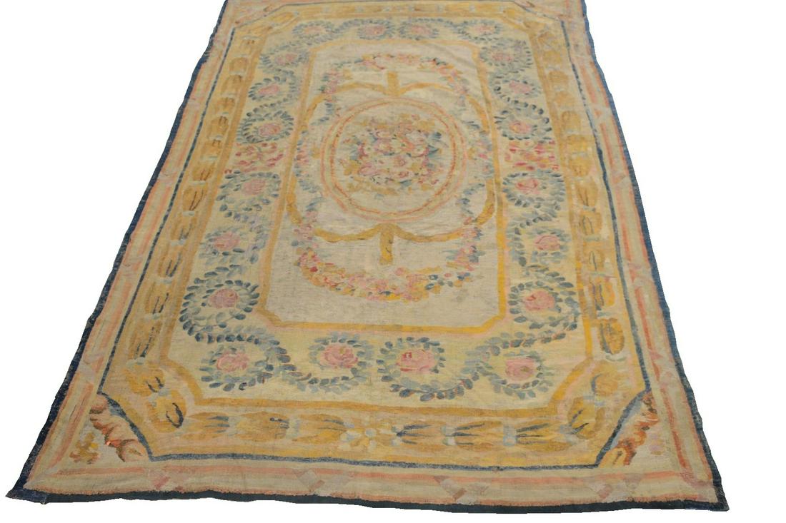 French Aubusson Carpet having central floral design and: French Aubusson Carpethaving central floral design and floral borders, bordered by linesprobably 18th century(backed, very worn, threadbare)9' 4" x 13' 5"