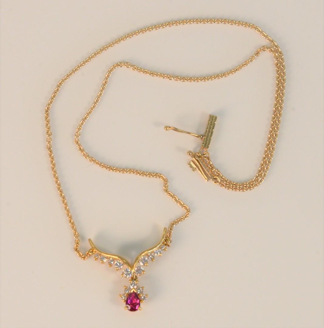 14 Karat Yellow Gold Chain with Pendant set with ruby: 14 Karat Yellow Gold Chain with Pendantset with ruby and fifteen diamondslength 14 1/2 inches6.2 grams total weightProvenance: The Estate of Diana Atwood Johnson