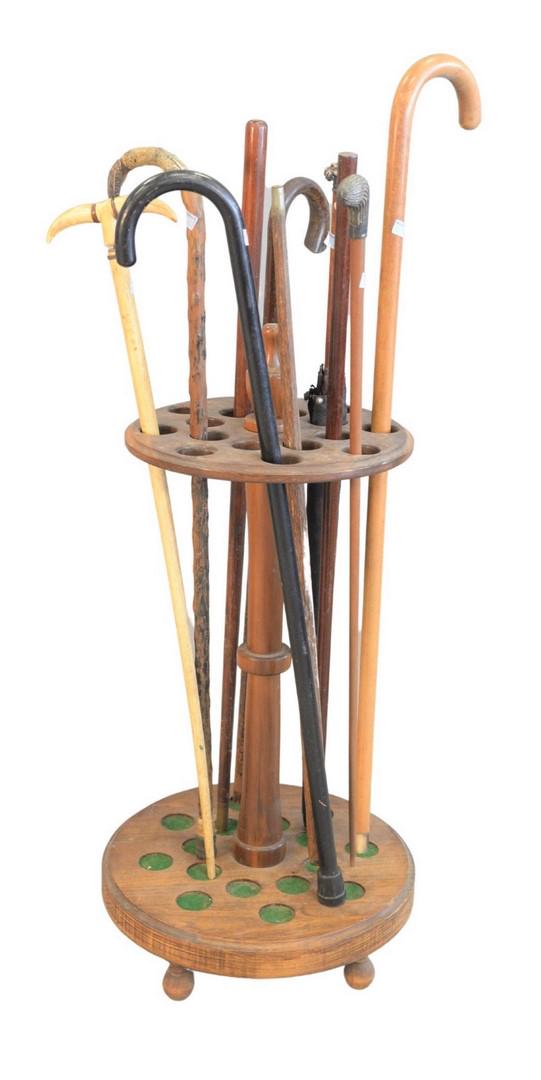 Pool Cue Stand to include eight canes, one umbrella,: Pool Cue Standto include eight canes, one umbrella, three with silver tops, one lion face with red eyes, one whale boneearly 19th Centurymissing spacerProvenance: Thirty-five year collection of Dana C
