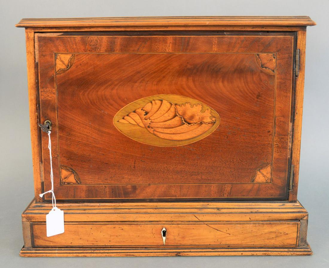 Mahogany Inlaid One Door Cabinet having inlaid shell on: Mahogany Inlaid One Door Cabinethaving inlaid shell on door, opening to fitted interior over one drawerheight 14 1/4 inches, width 16 3/4 inches, depth 5 1/2 inches