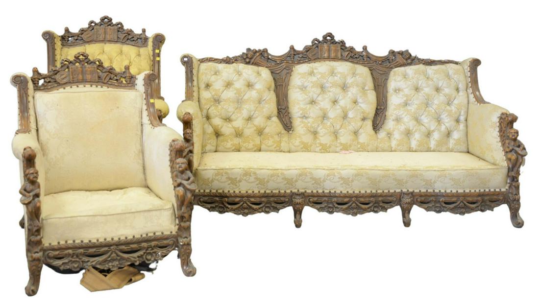 Carved Sofa and Two Chairs each with carved putti,: Carved Sofa and Two Chairseach with carved putti, cornucopia, fruit, and musicin need of upholstery and cushions