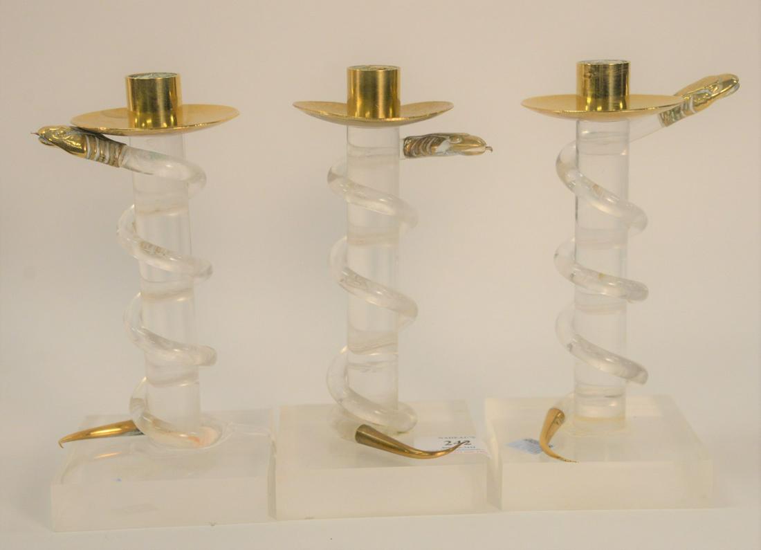 Three Alessandro Albrizzi Candlesticks, Lucite with: Three Alessandro Albrizzi Candlesticks, Lucite with snake motif, 20th Century; height 8 inches. Provenance: The Estate of Gloria Schiff, 630 Park Avenue, New York.