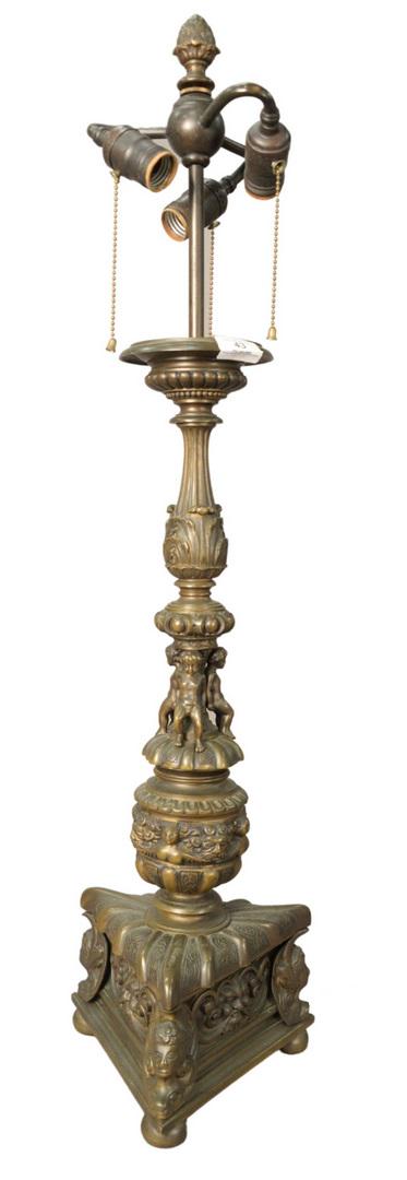 Bronze Baroque Style Table Lamp, having three lights: Bronze Baroque Style Table Lamp, having three lights and three putti figures mounted to the base, possibly Caldwell, overall height 35 inches.