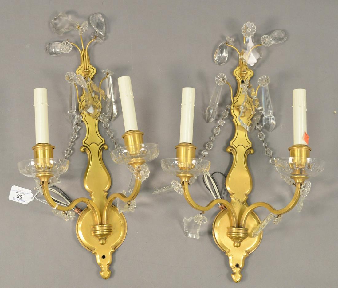 Pair of Brass and Rock Crystal Two Light Wall Sconces,: Pair of Brass and Rock Crystal Two Light Wall Sconces, having crystal drops and floral forms, height 11 inches, width 19 1/2 inches.