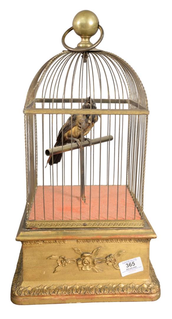 19th Century or Later Giltwood and Brass Automaton Bird: 19th Century or Later Giltwood and Brass Automaton Bird Cage, having mechanical singing bird in brass cage with music box case, moving head, in working condition, height 20 inches, width 9 1/2 inches,