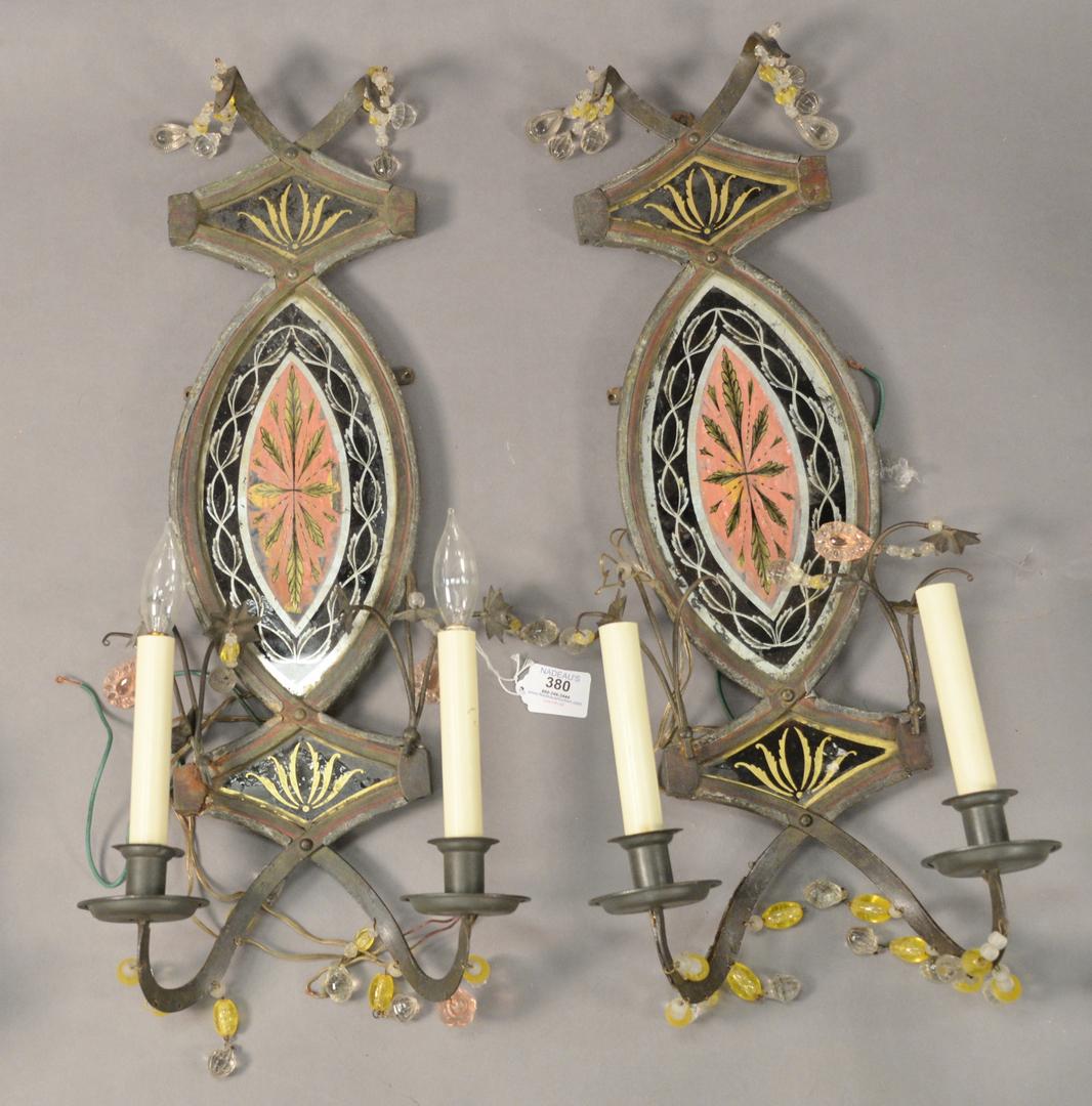 Pair of Tole and Reverse Glass Painted Sconces, having: Pair of Tole and Reverse Glass Painted Sconces, having two lights each and glass bead drops, height 22 inches, width 10 1/2 inches.