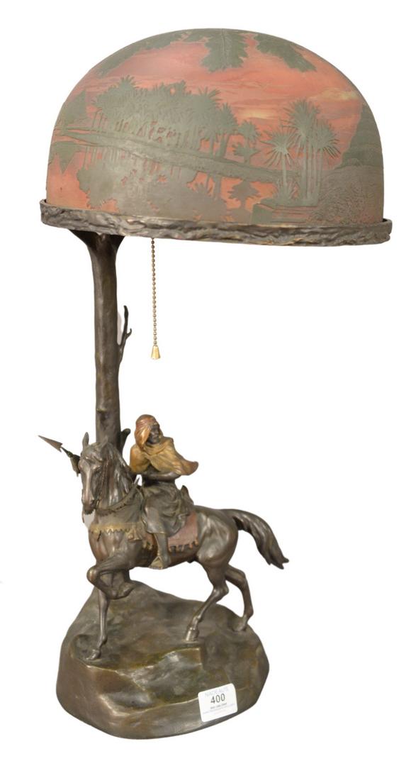Arsall/Gadek Orientalist Cameo Glass and Bronze Table: Arsall/Gadek Orientalist Cameo Glass and Bronze Table Lamp, having etched glass shade with orientalist scene of a Middle Eastern man on a camel with Egyptian pyramids, circa 1900 or later, bronze sign