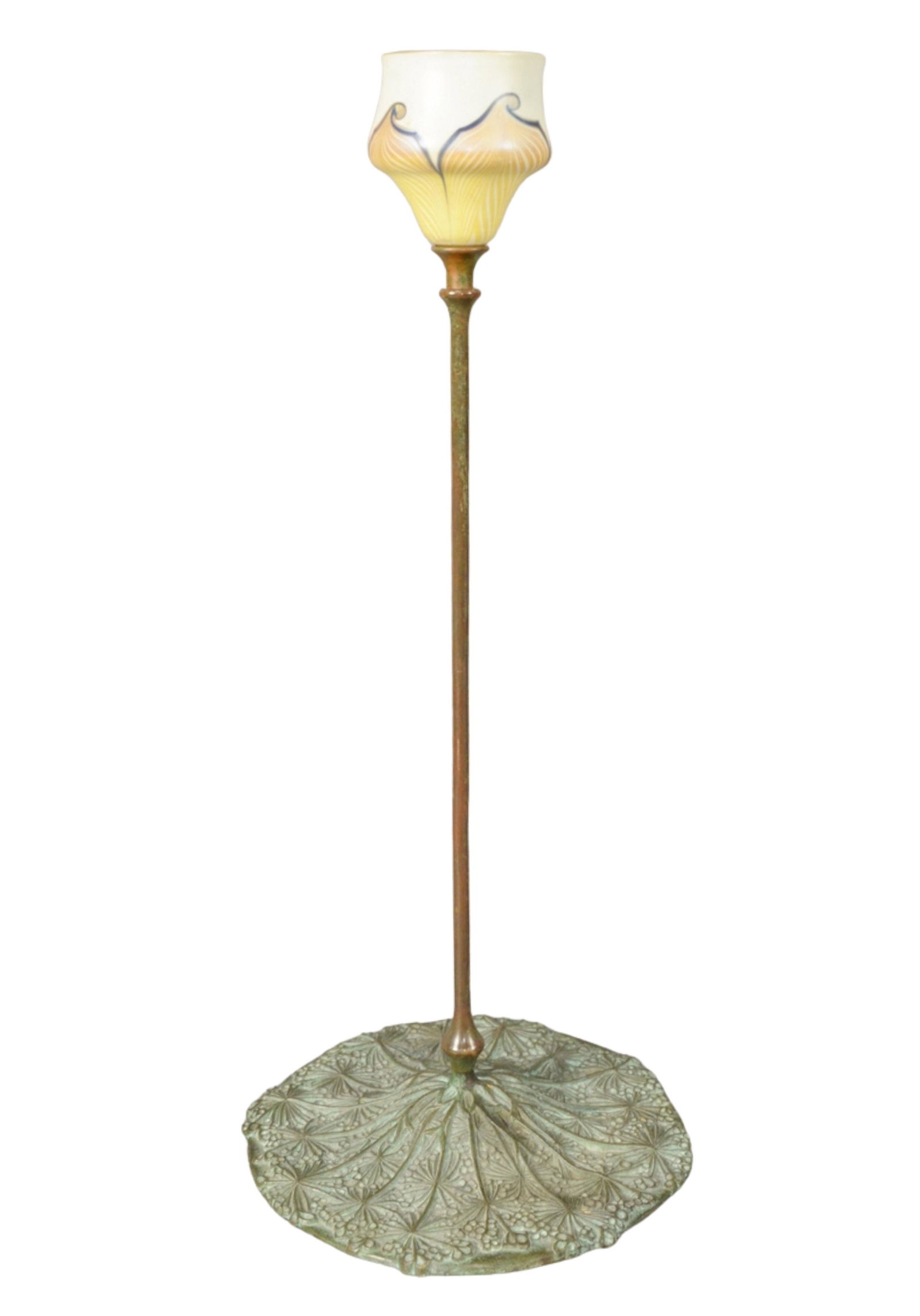 Tiffany Studios Candlestick having large bronze base: Tiffany Studios Candlestick having large bronze base with pull feather art glass shade, marked to the underside '291 Tiffany Studios, New York' height 19 inches, base diameter 8 1/2 inches.