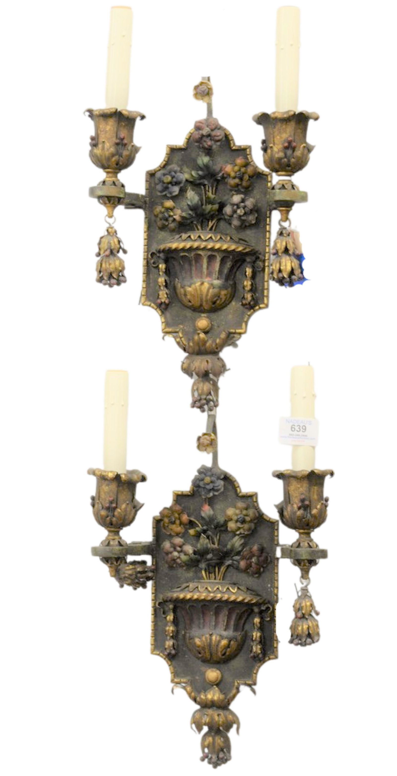 Pair of Iron and Bronze Two Light Wall Sconces having: Pair of Iron and Bronze Two Light Wall Sconces having painted floral and urn form decoration, height 14 1/2 inches, width 9 inches.