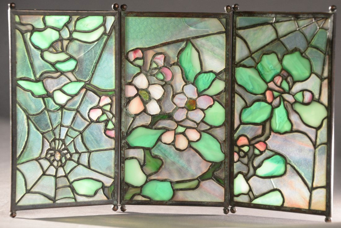 Tiffany Studios "Spider" Tea Screen, having three leade: Tiffany Studios "Spider" Tea Screen, having three leaded glass panels with patinated bronze having apple blossom with spider web on ball feet, height 7 3/4 inches, width 12 inches.
