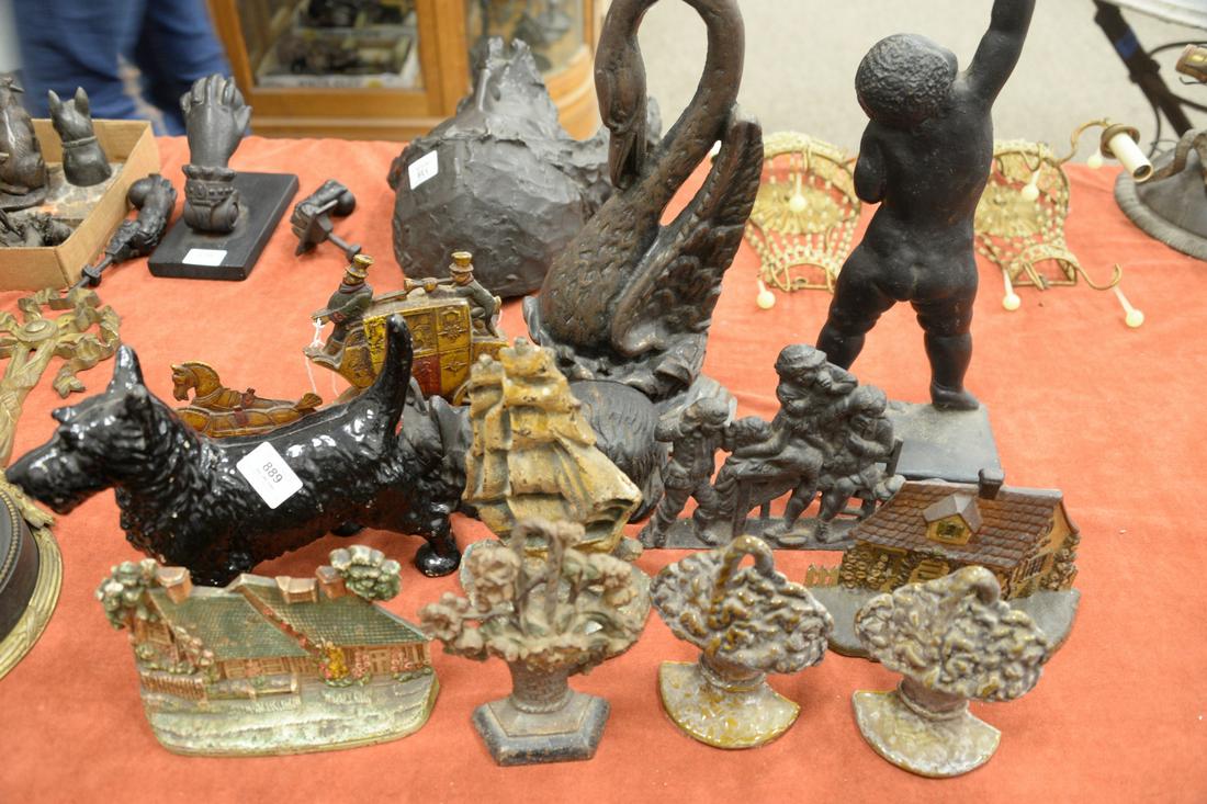 Twelve Cast Iron and Painted Doorstops, to include two: Twelve Cast Iron and Painted Doorstops, to include two in the form of Scotties; one sailing ship; a horse and carriage; two cottages; two urn forms; along with a figural door stop, height 8 inches, wi