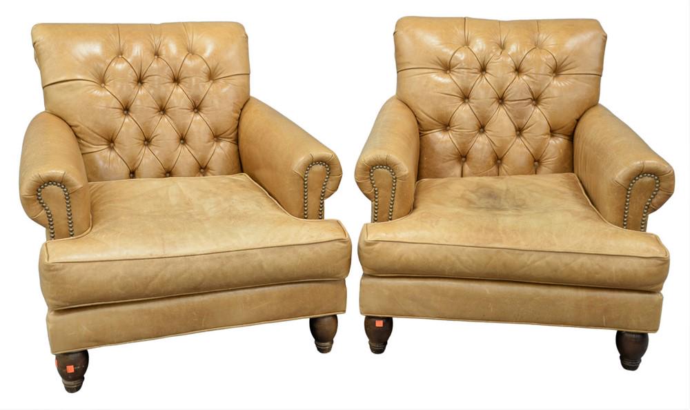 Pair of Leather Armchairs, having tufted backs and: Pair of Leather Armchairs, having tufted backs and brass tack details on the arms (soiled), height 33 inches, width 33 inches, depth 32 inches.